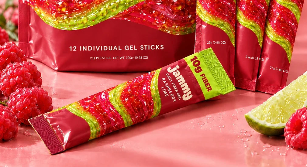 Close-up of the same Jammy raspberry-lime packaging, with matching small cream serving-size lettering, fresh raspberries and lime