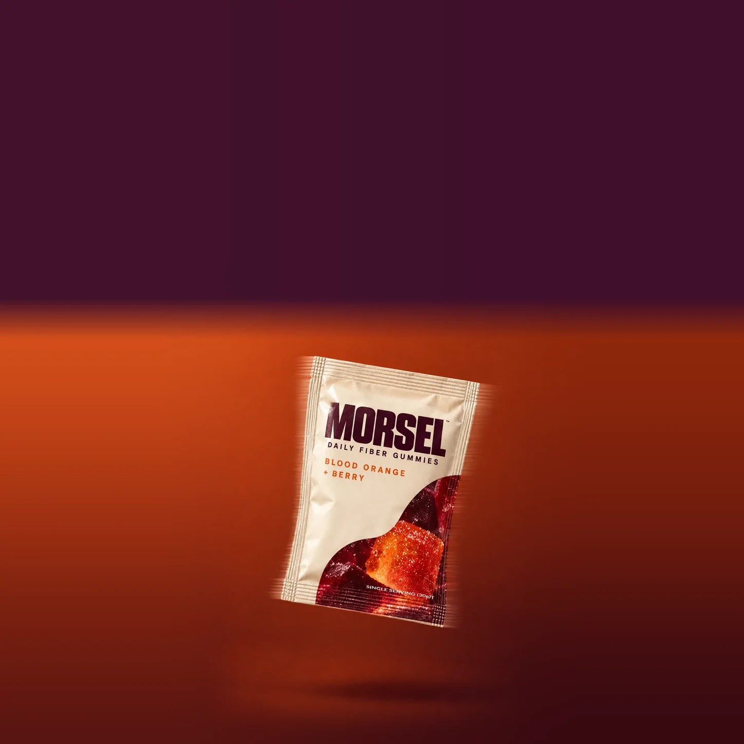 Morsel's cream pouch captured mid-turn with subtle motion trails against a warm orange studio background